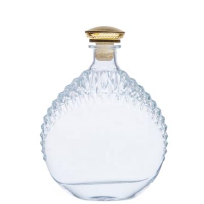 China Special Liquor Custom Carved Round Brandy Empty Glass Wine Bottle for sale