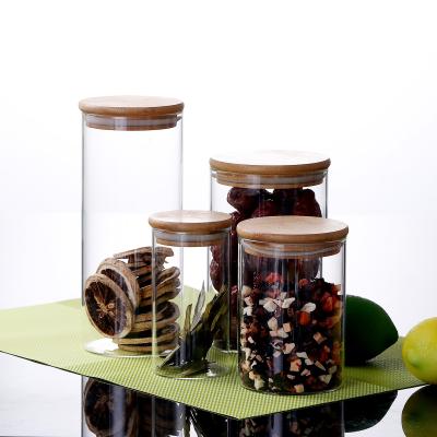 China Clear Borosilicate Glass Airtight Storage Jar With Wooden Glass Jar Lid for sale