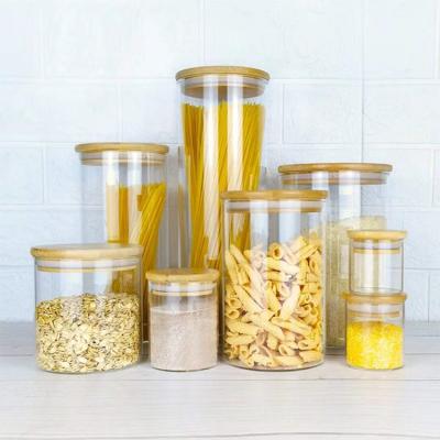 China Heatable High Borosilicate Bamboo And Wood Cover Straight Glass Grain Sealing Moisture Proof Tea Can Glass Storage Jar for sale