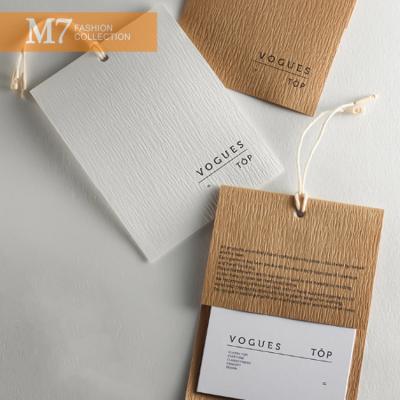 China DP085 Custom Cardboard Swing Hang Tag Designs Garment Paper Tags Sustainable High Quality for sale