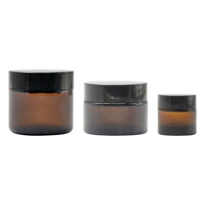 China Wishing Wholesale Empty 5g 10g 15g 30g Small Glass Jar With Lid Cosmetic Frosted Amber Glass Jar Skin Care Face Eye Cream for sale