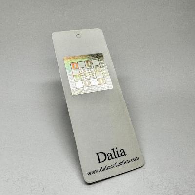 China Recyled Custom Offset Print Hang Tag Hot Stamp In Silver Foil Swing Tag Recycle Paper Made With Hologram Anti-Counterfeiting Sticker for sale