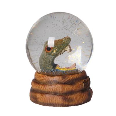 China Custom Water Globe Animal Snow Europe Resin Water Globe Creative Watering Dinosaur Shape Snow Globe Resin Ornament Gift for sale