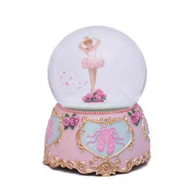 China Europe Resin Opens Pink Ballet Girl Snow Globe Music Rotating Crystal Ball Ornament Luxury Pink Light Ballerina Snow Globe for sale