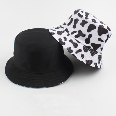 China Fashion \ comfortable \ durable hot selling side pattern cow print reversible one fashion another retro solid color style bucket hat wholesale for sale