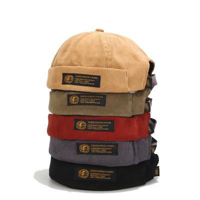 China COMMON Wholesale Hot Selling Brimless Streetwear Corduroy Skull Hat Docker Retro Unisex Leather Strap Hat for sale