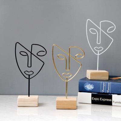 China Nordic Europe style modern decoration abstract face home decoration pieces metal iron decoration wooden simple table crafts for sale