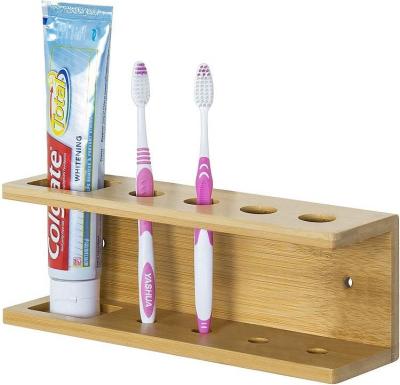 China Sustainable Wall Mounted Bamboo Toothbrush and Toothpaste Rack Bathroom Shelf Storage Shelf for sale