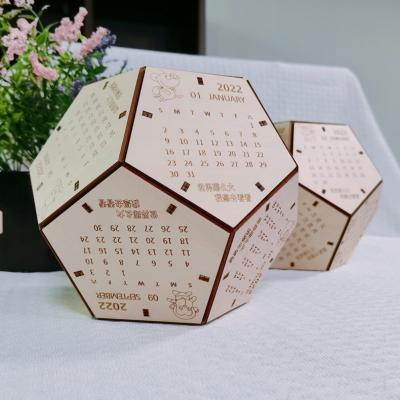 China Presentation Gift Set Dodecahedron Promotional Wooden Desk Block Ornaments Christmas Calendar 2022 Gift Football Perpetual Calendar For Friends for sale