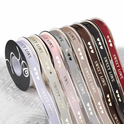 China Luster Factory wholesale gold edge love and heart solid custom foil printed satin ribbon roll for flower bouquet for sale