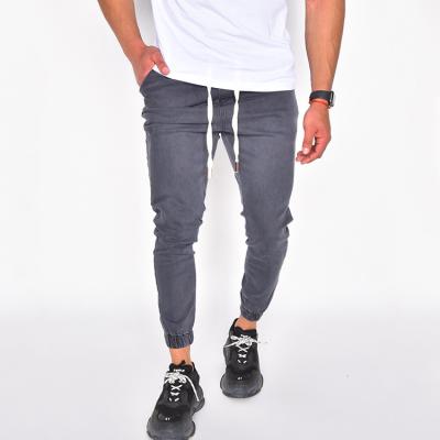 China 2021 New Hot Sale Breathable Men Fashion Jeans Wild Sporty Denim Fabric Slim Fit Jogger Pants With Waisted String for sale