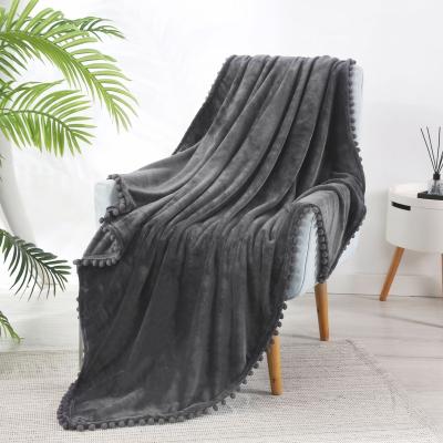 China 2022 Hot Best Selling Soft Solid Color Flannel Fleece Blanket With Ball Tassels for sale