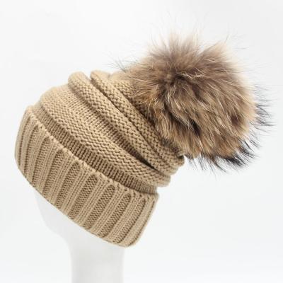 China Autumn and winter raccoon dog hair pom wool beanie hat women's COMMON cashmere hat knitted warm double layer pompom ball hat for sale