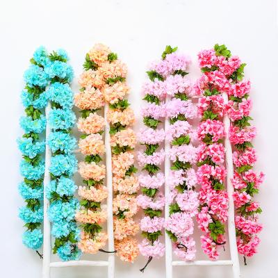 China Fashionable Wholesale Artificial Flowers Hanging Vine Cherry Plants Artificial Hanging Flowers for Wall Wedding Garden Decoration for sale