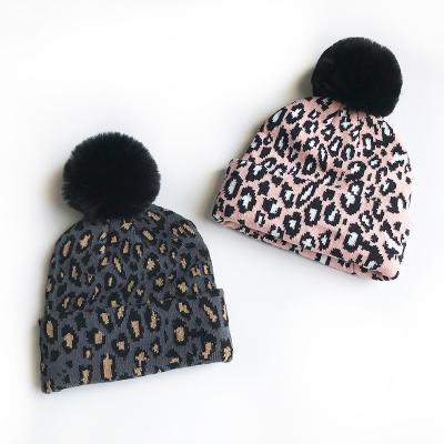 China COMMON Warm Stylish Soft Messy Pompom Knitted Beanie Hat Leopard Bun Hat Winter Knit Crochet Flip Hat For Kids for sale