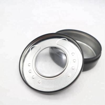 China Recyclable Embossed Matte Black Round Tin Box With Window For Horseshoe Packaging for sale