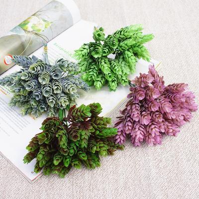 China Indoor and outdoor wholesale plant background decoration pine cone simulation plastic grass indoor decoration for sale