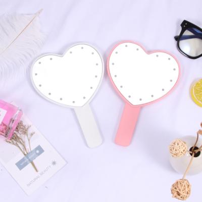 China Custom Made Vanity Mirror New Arrival Glitter Cute Small Pocket Lighted Logo Portable Heart Shape LED Handheld Makeup Mirror for sale