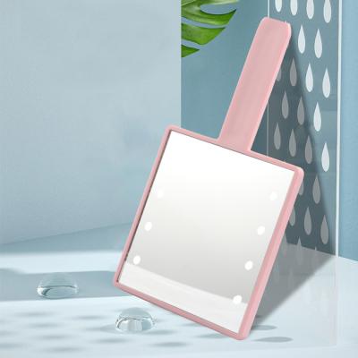 China Mini Lovely Pink Square Shape Lighted Touch Screen Customized Logo Small Hand Held Side Makeup Mirror With Led Light for sale