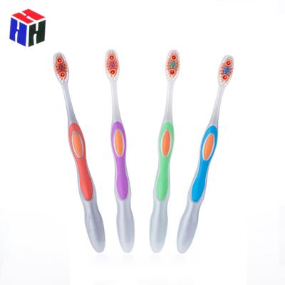 China Custom Plastic New Home Use Wholesale Design Tapered Stiffens Adult Toothbrush With Colorful Soft Rubber Grip for sale