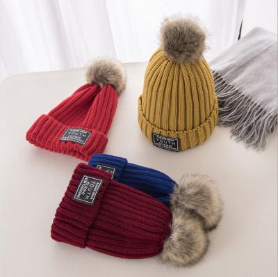 China JOINT New Fashion Custom Logo On Front Knitted Woolen Twist Beanie Hat With Ball On Top for sale