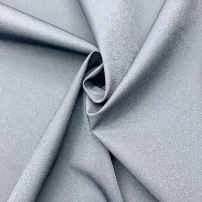 China Cuatro vías de estiramiento de nylon reciclado de tela de spandex semi brillante torcido 70D 158GSM en venta