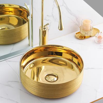 China Factory Wholesale Luxury Ceramic Brush Gold Color Gold Face Wash Basin With Ring Design For Bathroom for sale