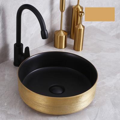 China Luxury Gold Black Gold Color Round Wash Sink Luxury Modern Countertop Gold Ceramic Bathroom Wash Basin for sale