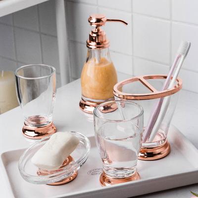 China Sustainable Luxury Rose Gold Household Wash Cup Bathroom Supplies Kit Toothbrush Holder Set Glass Transparent Bathroom Set for sale