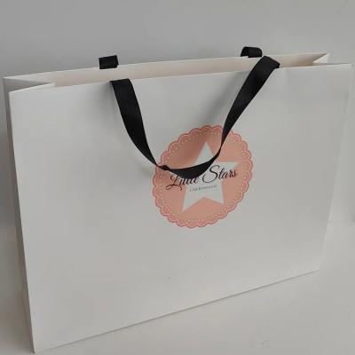 China Custom Printed Ribbon Handle White Cardboard Shopping Packaging Bag Customized Luxury Paper Gift Bags With Your Own Logo for sale