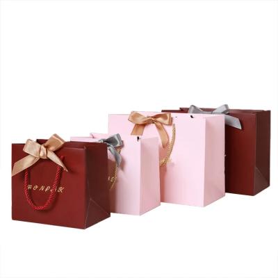 China customized mini shopping paperbags pink paper bag with handles and logo print for sale