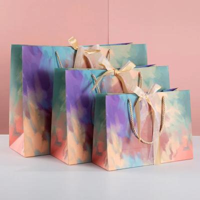 China Personalized Custom Logo Luxury Paper Bags Gift Packing Ribbon Colorful Craft Paper Bag with Handle for sale