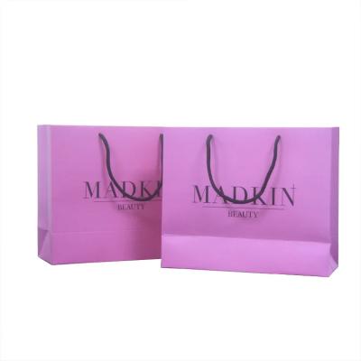 China Purple paper gift bags mall rose light pink holographic cosmetic shopping paper bags with handles cute for sale