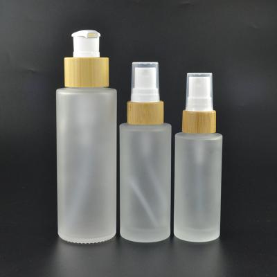 China Hot sale 30ml 50ml 100ml 120ml 150ml frosted clear 4 oz glass spray bottle with bamboo pump sprayer for sale