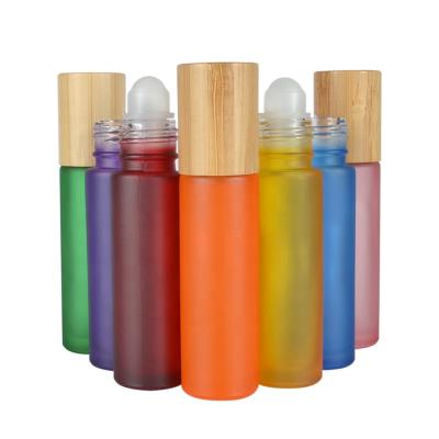 China Hot sale essential oil luxury 10ml clear pink black green blue roll on glass bottle with bamboo cap for sale