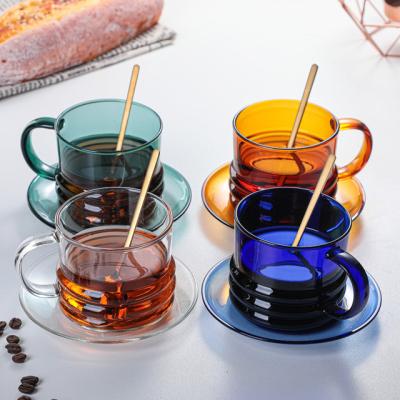 China Sustainable Durable Using Colored Handmade Glass Cup High Borosilicate Insulated Glass Mug With Handle And Saucer Set for sale