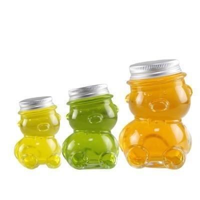 China Professional Empty Glass Jar Tilted Head Bear Shaped Glass Jar for sale