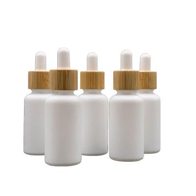 China 15ml 20ml 30ml 50ml 100ml Black Matte Dropper Bottles With Bamboo Frosted White Refillable Dropper For Beard Oils for sale