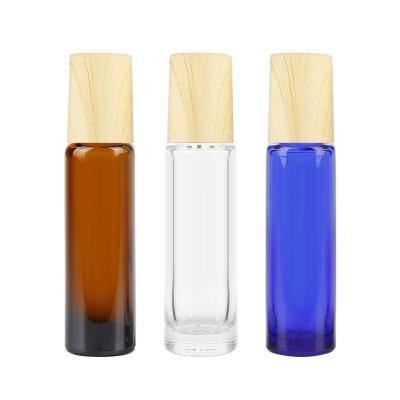 China Cosmetic Clear Refillable Glass Essential Oil Roll On Bottle With Bamboo Steel Rollball Essential Oil Bottle for sale