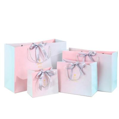 China Retail Custom Logo Colorful Printing Luxury Clothing White Paper Shopping Bag Ribbon Closing Gift Tissue Paper Bag Recyclable for sale