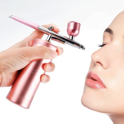 China Hot Mini Handheld Makeup Sprayer Pigment Removal Facial Beauty Device Airbrush For Home Use for sale