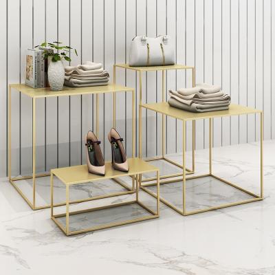 China High End Golden Stainless Steel Clothing Display Table For Women Clothing Store for sale