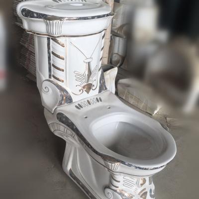 China Luxury Double-Flow Large Size Two Piece Ceramic Decorative Golden Toilet For UAE Market for sale