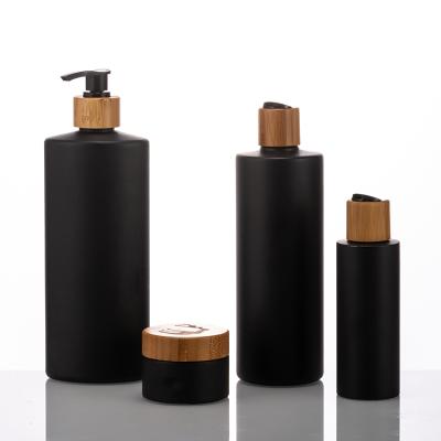 China BEAUTY PACKAGING 200ml 300ml 500ml round shape PE bottle with bamboo collar for shower gel bottle packaging for sale