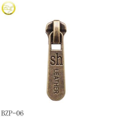 China Nickel Free Antique Brass Jacket Zipper Slider Letters Brand Logo Metal Zipper Puller For Bags for sale