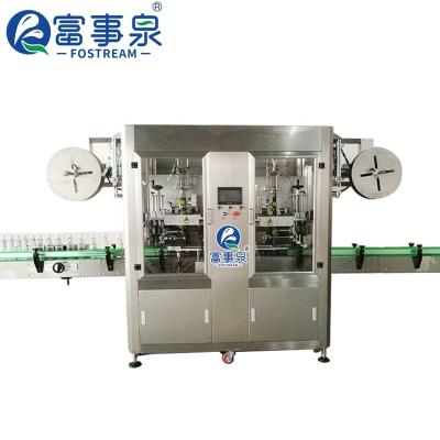 China High Speed ​​Full Automatic Double Heat Beverage Shrink Head Sleeve Bottle Labeling Machine For Bottle Body And Cap for sale