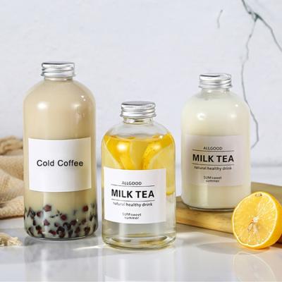 China Sale 350ml 500ml 16oz Empty Round Luxury Beverage Tea Milk Glass Bottle With Screw Lids for sale