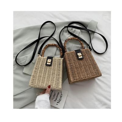 China 2021 New Fashion Handmade Straw Bag Small Round Bamboo Lock Handle Straw Bucket Bags Lady Summer Beach Travel Purses and Handbags for sale