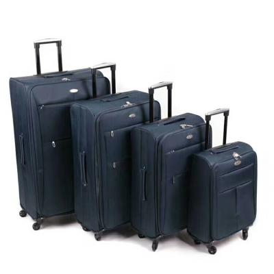 China Lightweight Polyester Grid Fabric Softshell Spinner 4 Wheels 360 Degree 4pcs Trolley Luggage Set for sale