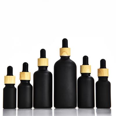 China 5ml 10ml 15ml 20ml 30ml 50ml 100ml Cosmetic Matte Black Essential Oil Serum Glass Dropper Bottle With Bamboo Cap for sale